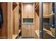 Walk-in closet with custom wood shelving and built-in storage for clothing and accessories at 9643 E Legacy Ridge Rd, Scottsdale, AZ 85262