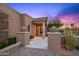 Elegant front entrance with stone accents, potted plants, and a view through the glass door at 9643 E Legacy Ridge Rd, Scottsdale, AZ 85262