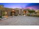 Beautiful exterior of a home with a stone accent wall and a paved driveway at 9643 E Legacy Ridge Rd, Scottsdale, AZ 85262