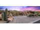 Luxury home exterior with desert landscaping, including cacti and succulents and a circular driveway at 9643 E Legacy Ridge Rd, Scottsdale, AZ 85262