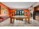 Recreation room with a pool table, shuffleboard, fireplace, and great views of the property at 9643 E Legacy Ridge Rd, Scottsdale, AZ 85262