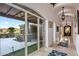 Hallway leading to outdoor patio with desert views, featuring tile floors and elegant lighting fixtures at 9643 E Legacy Ridge Rd, Scottsdale, AZ 85262