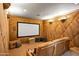 Dedicated home theater with comfortable seating, a large screen, and custom wood paneling at 9643 E Legacy Ridge Rd, Scottsdale, AZ 85262