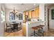 Kitchen featuring bar seating, and an adjacent dining area with a view of the outdoors at 9643 E Legacy Ridge Rd, Scottsdale, AZ 85262
