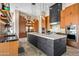 Open kitchen featuring a large island, modern appliances, custom cabinetry, and pendant lighting at 9643 E Legacy Ridge Rd, Scottsdale, AZ 85262