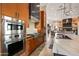 Gourmet kitchen featuring stainless steel appliances, a gas cooktop, and designer tile backsplash at 9643 E Legacy Ridge Rd, Scottsdale, AZ 85262