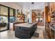 Bright, open kitchen with a large center island, custom shelving, and an adjacent outdoor dining area at 9643 E Legacy Ridge Rd, Scottsdale, AZ 85262