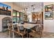 Open-concept kitchen and dining area with a large island, modern lighting, and mountain views at 9643 E Legacy Ridge Rd, Scottsdale, AZ 85262