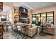 Comfortable living room with modern fireplace, entertainment center, and sliding glass doors to patio at 9643 E Legacy Ridge Rd, Scottsdale, AZ 85262