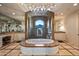 Luxurious main bathroom featuring a soaking tub, walk-in shower, and stunning mountain views at 9643 E Legacy Ridge Rd, Scottsdale, AZ 85262