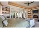 Bright main bedroom with fireplace, outdoor access, and decorative shelving at 9643 E Legacy Ridge Rd, Scottsdale, AZ 85262