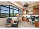 Bright home office with a large window overlooking the desert landscape, built-in shelving, and comfortable seating at 9643 E Legacy Ridge Rd, Scottsdale, AZ 85262