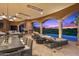 Inviting outdoor space featuring lounge chairs, fireplace, and dining area for serene enjoyment at 9643 E Legacy Ridge Rd, Scottsdale, AZ 85262