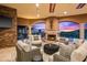 Comfortable outdoor living area with fireplace, seating, and views of the desert sunset at 9643 E Legacy Ridge Rd, Scottsdale, AZ 85262