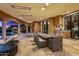 Spacious outdoor living area with a dining table, grill, ping pong table and comfortable lounge chairs at 9643 E Legacy Ridge Rd, Scottsdale, AZ 85262