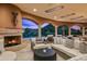 Stunning outdoor patio with a fireplace, stylish seating, and mountain views at 9643 E Legacy Ridge Rd, Scottsdale, AZ 85262