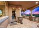 A covered outdoor patio showcases stone pillars, arches and views of the surrounding landscape at 9643 E Legacy Ridge Rd, Scottsdale, AZ 85262