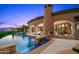 Resort-style pool with an outdoor fireplace, a cozy seating area, and elegant archways at 9643 E Legacy Ridge Rd, Scottsdale, AZ 85262