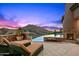 Relaxing poolside with lounge chairs, fire feature, and mountain views at 9643 E Legacy Ridge Rd, Scottsdale, AZ 85262