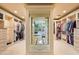 Spacious walk-in closet with custom shelving, cabinets, and a clear view into the luxurious bathroom at 9643 E Legacy Ridge Rd, Scottsdale, AZ 85262
