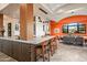 Wet bar with barstool seating connects to dining area with views through a picture window at 9643 E Legacy Ridge Rd, Scottsdale, AZ 85262