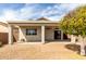 Backyard showcasing a covered patio, low-maintenance gravel, and a vibrant fruit tree at 9733 W Purdue Ave, Peoria, AZ 85345