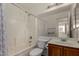 Bright bathroom featuring a shower-tub combination and a wood vanity with a mirror at 9733 W Purdue Ave, Peoria, AZ 85345