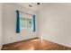 Bright bedroom showcasing wood floors, a window with coverings, and neutral walls at 9733 W Purdue Ave, Peoria, AZ 85345