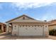 Beige single-story home featuring a two-car garage and low-maintenance gravel landscaping at 9733 W Purdue Ave, Peoria, AZ 85345