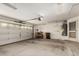 Spacious two-car garage with an automatic door, built-in shelving, and a water heater at 9733 W Purdue Ave, Peoria, AZ 85345