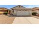 Beige single-story home featuring a two-car garage and low-maintenance gravel landscaping at 9733 W Purdue Ave, Peoria, AZ 85345