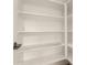 Walk-in pantry features white shelving offering ample storage, which helps keeps things organized at 9733 W Purdue Ave, Peoria, AZ 85345
