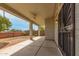 Covered patio area with a ceiling fan, concrete flooring, and views of the backyard at 9733 W Purdue Ave, Peoria, AZ 85345