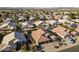 Wide aerial view of a neighborhood with many single-Gathering homes, desert landscaping, and beautiful mountain views at 9954 W Mohawk Ln, Peoria, AZ 85382