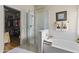 Primary bathroom featuring a glass shower, soaking tub, and walk-in closet at 9954 W Mohawk Ln, Peoria, AZ 85382