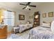 Cozy bedroom featuring twin beds, hardwood floors, a ceiling fan and decor at 9954 W Mohawk Ln, Peoria, AZ 85382