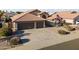 Charming single-story home with well-maintained landscaping, a two-car garage, and a classic Southwestern-style roof at 9954 W Mohawk Ln, Peoria, AZ 85382