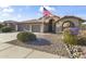 Charming single-story home with a well-kept yard, desert landscaping, and an American flag at 9954 W Mohawk Ln, Peoria, AZ 85382