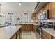 Well-equipped kitchen featuring wooden cabinets, modern appliances, and bright lighting at 9954 W Mohawk Ln, Peoria, AZ 85382