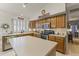Bright kitchen with an island, stainless steel appliances, and ample cabinet space at 9954 W Mohawk Ln, Peoria, AZ 85382
