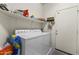 Functional laundry room equipped with a washer, dryer, shelving, and exterior door at 9954 W Mohawk Ln, Peoria, AZ 85382