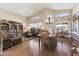 Cozy living room with hardwood floors, large windows, and comfortable seating at 9954 W Mohawk Ln, Peoria, AZ 85382