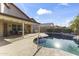 Backyard view showcases the pool, covered patio, lush landscaping, and tranquil ambiance at 9954 W Mohawk Ln, Peoria, AZ 85382