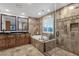 Luxurious bathroom featuring a soaking tub, walk-in shower, and double sinks at 10484 E Mission Ln, Scottsdale, AZ 85258