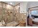 Stylish bathroom with tiled walls, glass shower, and view into the main bedroom at 10484 E Mission Ln, Scottsdale, AZ 85258