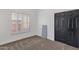 Bedroom with neutral carpet, black doors, and a window with white shutter coverings at 10484 E Mission Ln, Scottsdale, AZ 85258