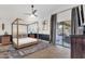 Stylish main bedroom with a platform bed, ceiling fan, and sliding glass doors to the patio at 10484 E Mission Ln, Scottsdale, AZ 85258
