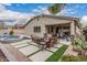 An outdoor living space with pool, spa, patio, fire pit and lush landscaping at 1078 W Redwood Ave, Queen Creek, AZ 85140