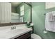 Bright bathroom featuring a large mirror and single vanity with updated faucet at 1078 W Redwood Ave, Queen Creek, AZ 85140