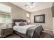 Inviting bedroom with a queen bed, ceiling fan, and bedside table at 1078 W Redwood Ave, Queen Creek, AZ 85140